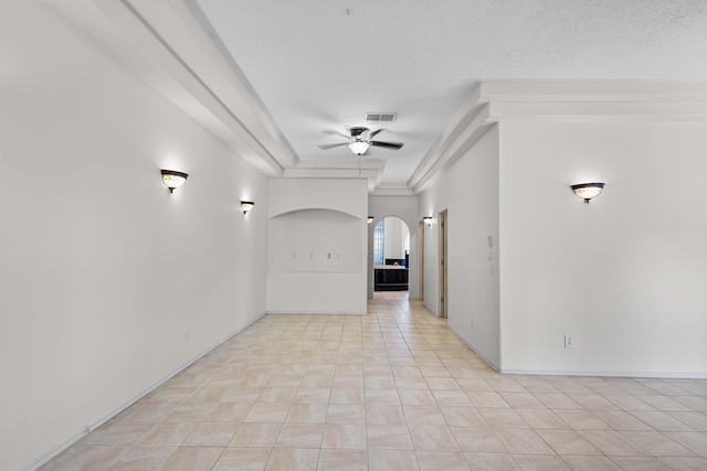 unfurnished room with a textured ceiling, light tile patterned flooring, and ceiling fan