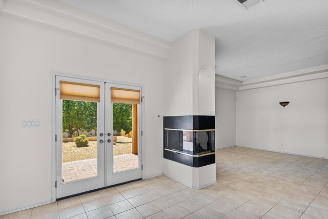 1220 Mesa Ridge Dr SW, Los Lunas, NM 87031 - spare room featuring french doors and light tile patterned floors