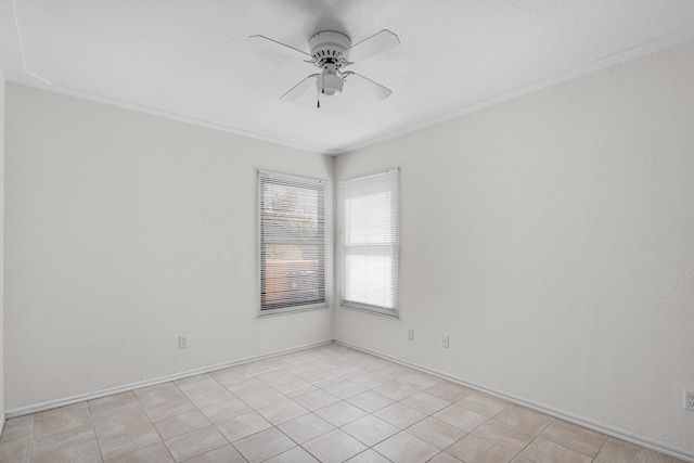 spare room featuring crown molding, light tile patterned flooring, and ceiling fan