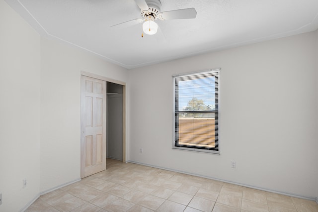 unfurnished bedroom featuring light tile patterned floors, ceiling fan, and a closet