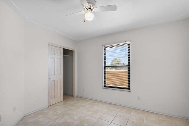 1220 Mesa Ridge Dr SW, Los Lunas, NM 87031 - unfurnished bedroom featuring a closet, a ceiling fan, and baseboards