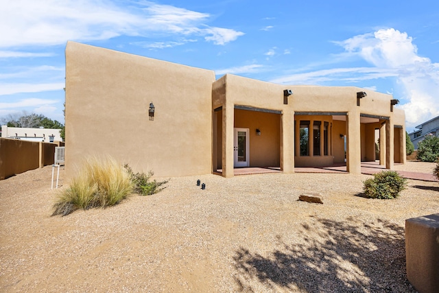 back of property with a patio