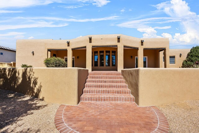 1220 Mesa Ridge Dr SW, Los Lunas, NM 87031 - entrance to property featuring stucco siding