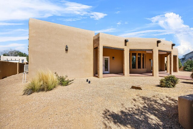 1220 Mesa Ridge Dr SW, Los Lunas, NM 87031 - rear view of house featuring stucco siding and a patio