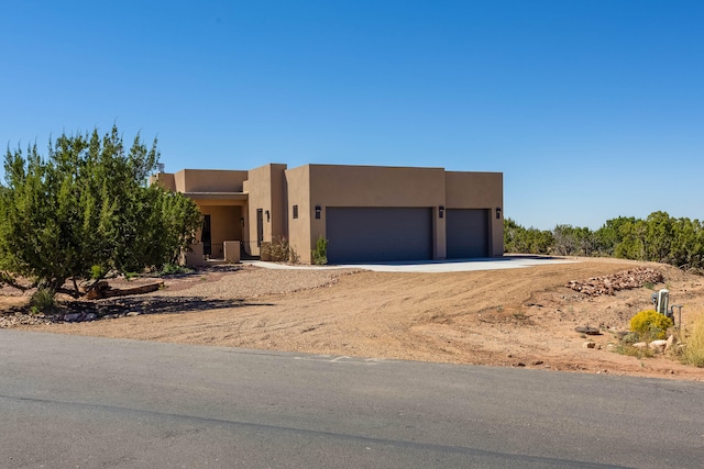 pueblo-style home featuring a garage