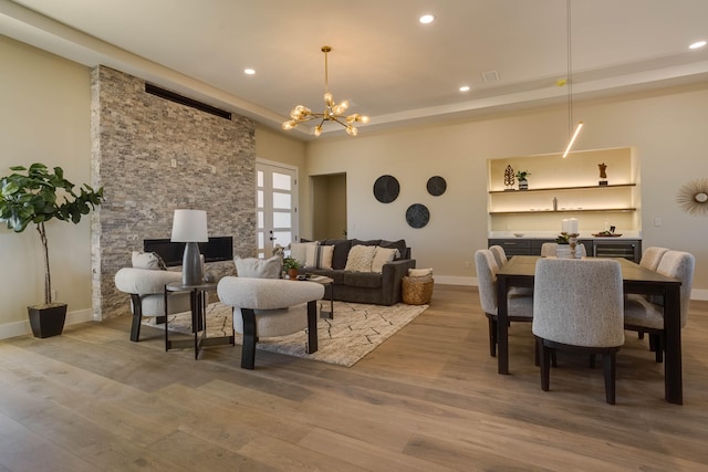 interior space featuring a fireplace, hardwood / wood-style floors, and a notable chandelier