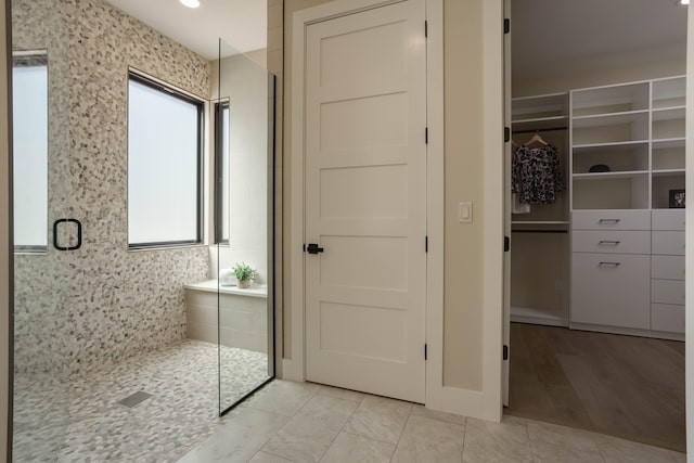 bathroom with wood-type flooring and a shower with shower door