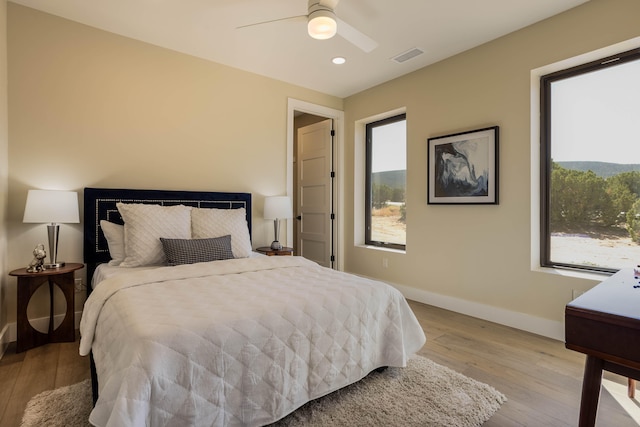 bedroom with light wood-type flooring and ceiling fan