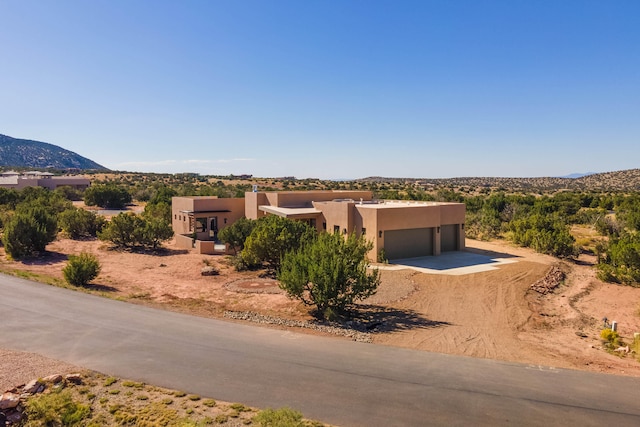 exterior space with a garage and a mountain view