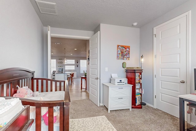 carpeted bedroom featuring a textured ceiling