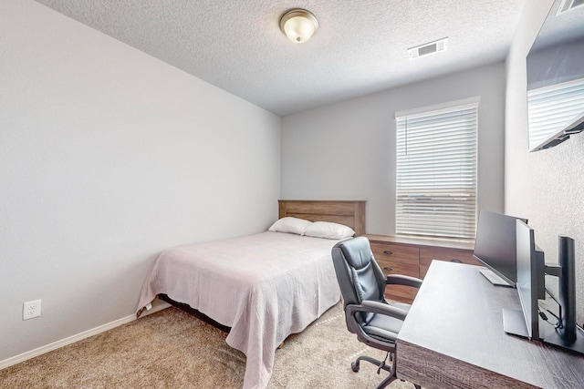 carpeted bedroom with a textured ceiling