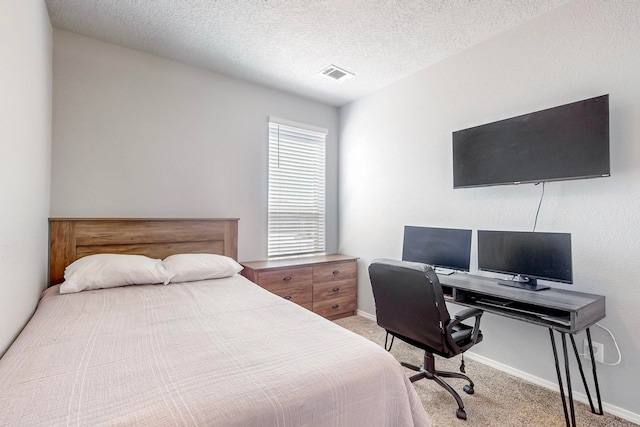 carpeted bedroom featuring a textured ceiling