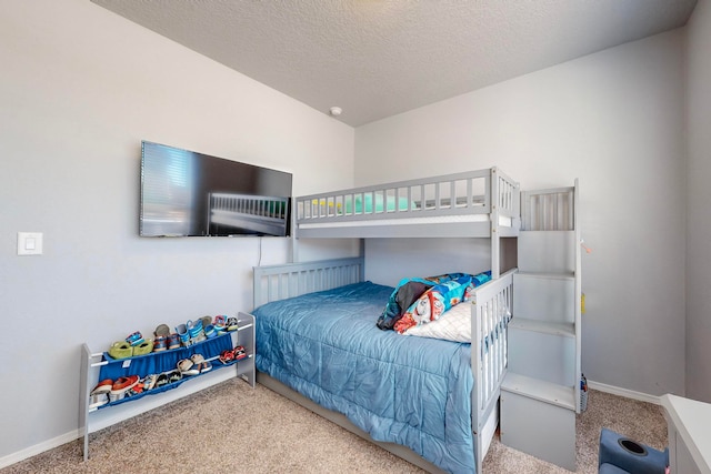 bedroom featuring carpet flooring and a textured ceiling