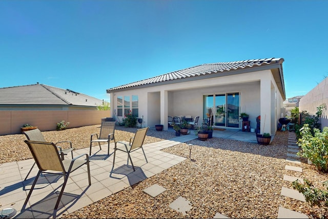 rear view of property featuring a patio area