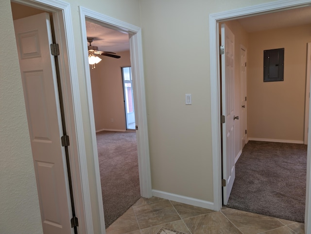 hallway featuring light carpet and electric panel