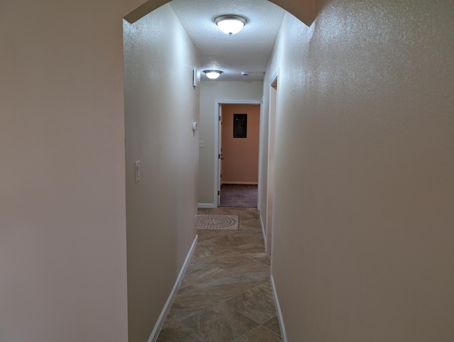 hallway featuring a textured ceiling