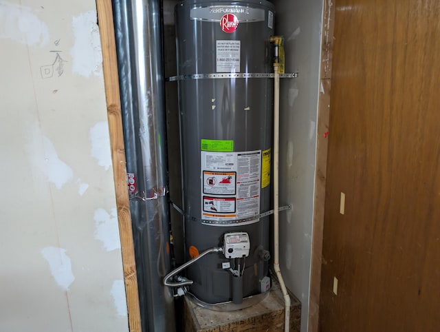 utility room featuring strapped water heater