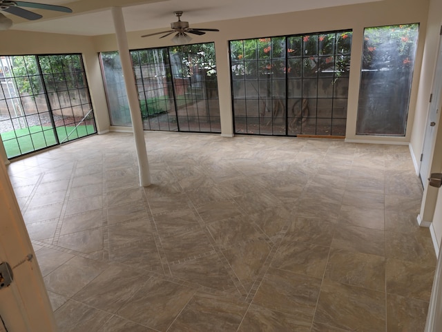 unfurnished sunroom featuring ceiling fan