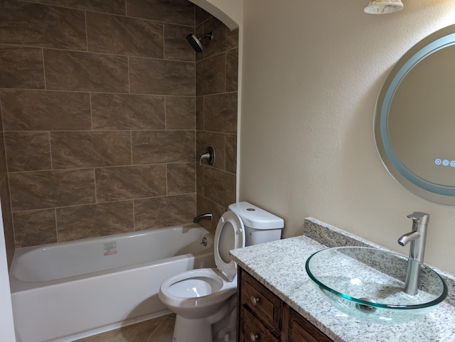 full bathroom featuring tiled shower / bath combo, vanity, toilet, and tile patterned floors