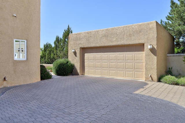 garage featuring decorative driveway