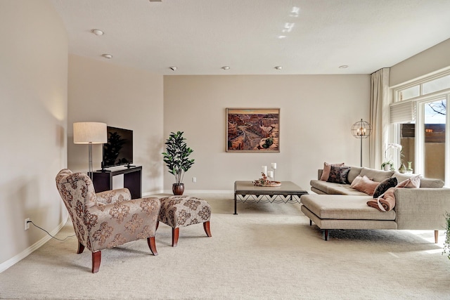 carpeted living room featuring baseboards