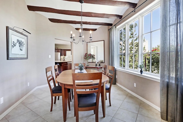 dining space featuring an inviting chandelier, beam ceiling, light tile patterned flooring, and baseboards