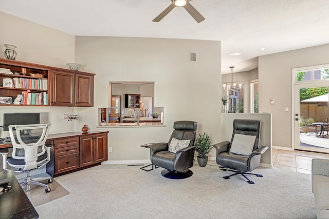 office space featuring baseboards, visible vents, built in desk, and light carpet