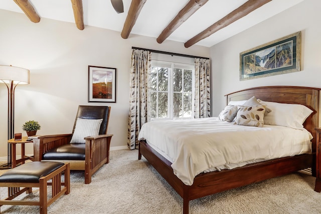 bedroom featuring beam ceiling, baseboards, carpet, and a ceiling fan