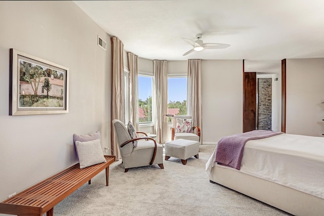 bedroom with ceiling fan, visible vents, and light carpet