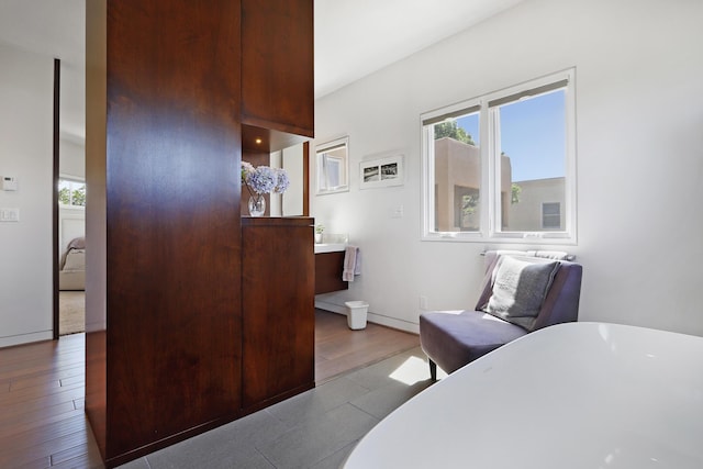 bedroom featuring wood finished floors and baseboards