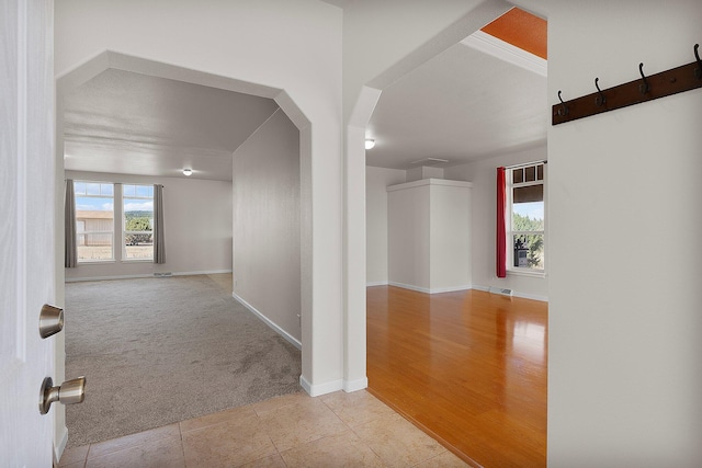 corridor with light hardwood / wood-style flooring