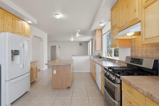 kitchen with light brown cabinets, a center island, sink, and white appliances