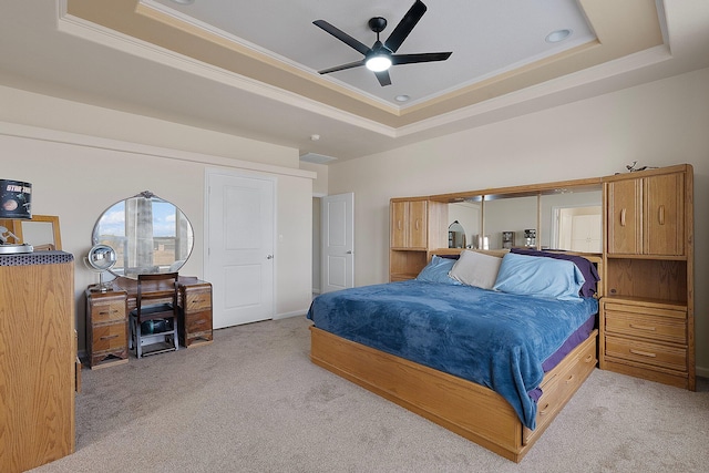 carpeted bedroom featuring ornamental molding, ceiling fan, and a raised ceiling