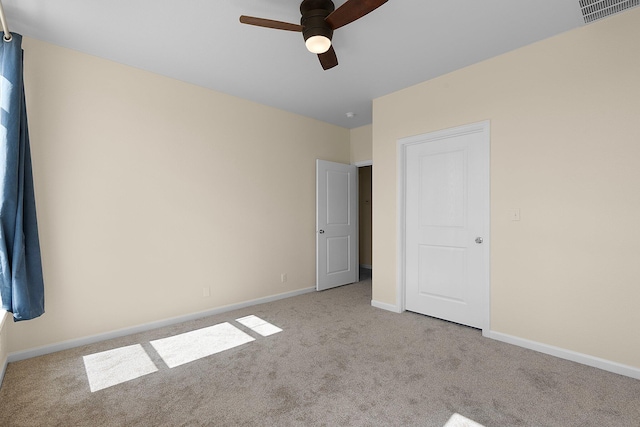 unfurnished bedroom featuring light colored carpet and ceiling fan