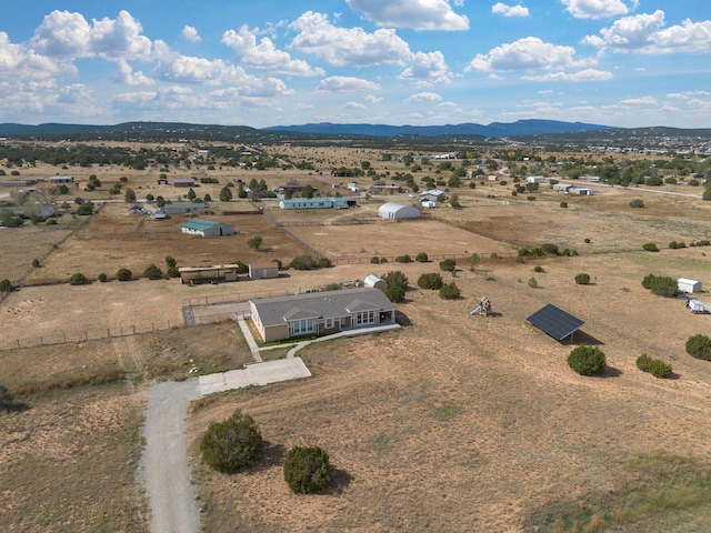 drone / aerial view featuring a mountain view and a rural view