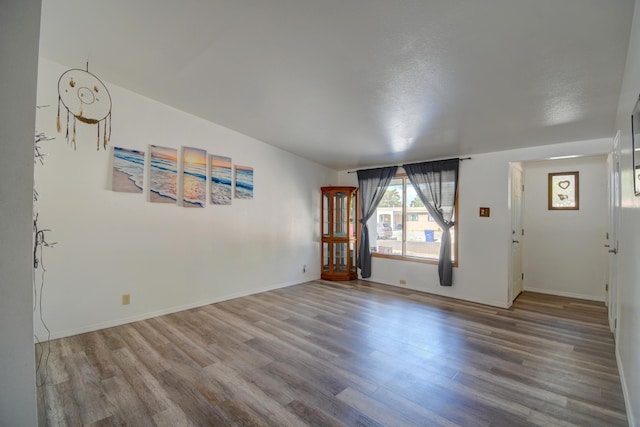 interior space featuring a textured ceiling and hardwood / wood-style flooring