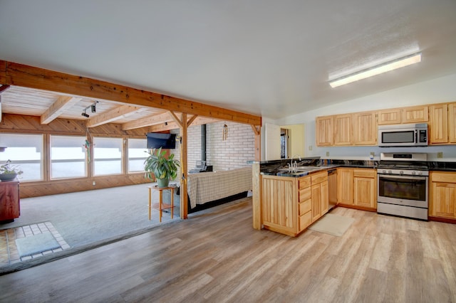 kitchen featuring vaulted ceiling with beams, appliances with stainless steel finishes, kitchen peninsula, and light brown cabinets