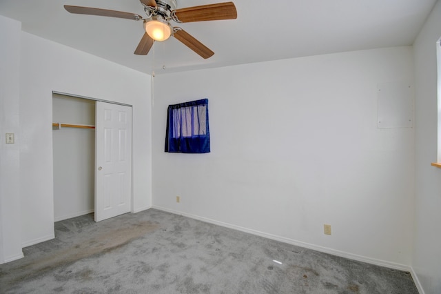 unfurnished bedroom with ceiling fan, light colored carpet, and a closet