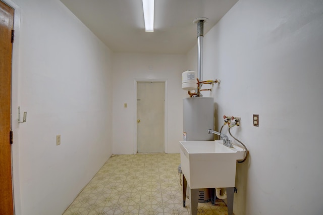 washroom featuring gas water heater and sink