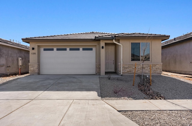 prairie-style home featuring stucco siding, stone siding, and driveway