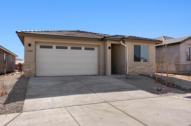 prairie-style house featuring an attached garage, stone siding, driveway, and stucco siding