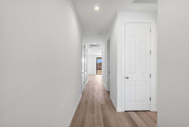 corridor featuring recessed lighting, light wood-style floors, visible vents, and baseboards