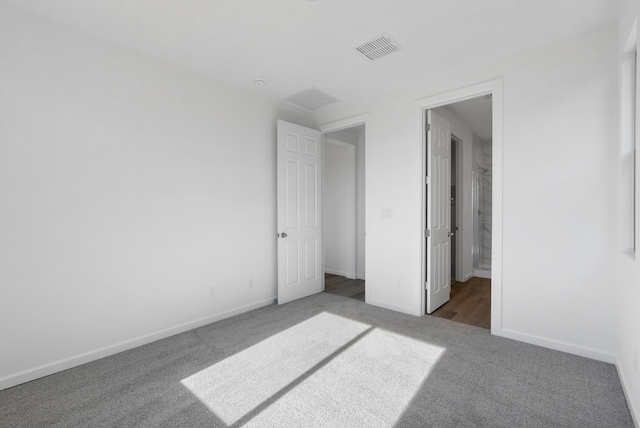 unfurnished bedroom featuring visible vents, baseboards, and carpet flooring