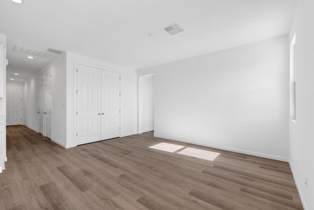 unfurnished bedroom with light wood finished floors, visible vents, recessed lighting, and baseboards