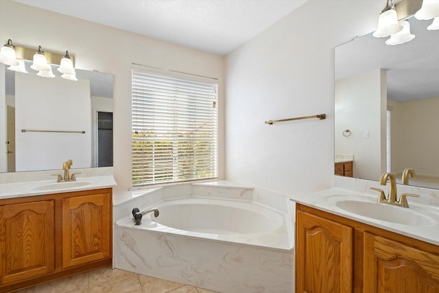 bathroom featuring vanity, a washtub, and tile patterned floors