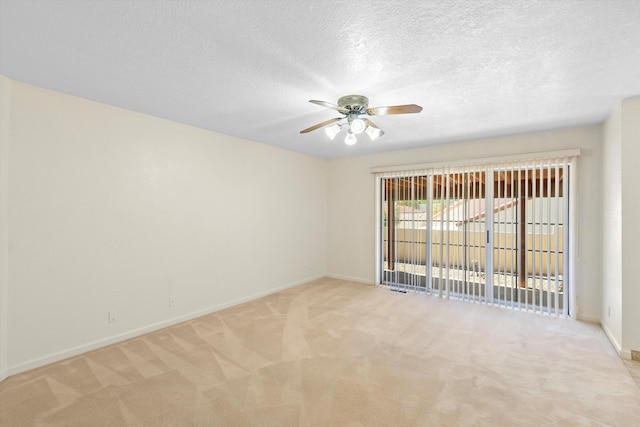 empty room featuring a textured ceiling, ceiling fan, and light colored carpet