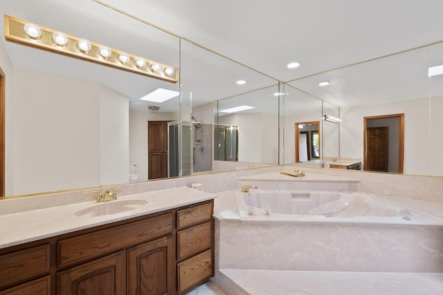 2616 Don Pedro NW, Albuquerque, NM 87104 - full bath featuring a stall shower, vanity, a garden tub, a skylight, and recessed lighting