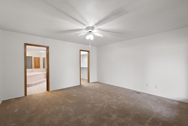 2616 Don Pedro NW, Albuquerque, NM 87104 - carpeted empty room featuring baseboards, visible vents, ceiling fan, and a textured ceiling