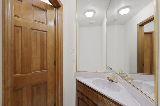 2616 Don Pedro NW, Albuquerque, NM 87104 - bathroom with vanity, visible vents, and a textured ceiling