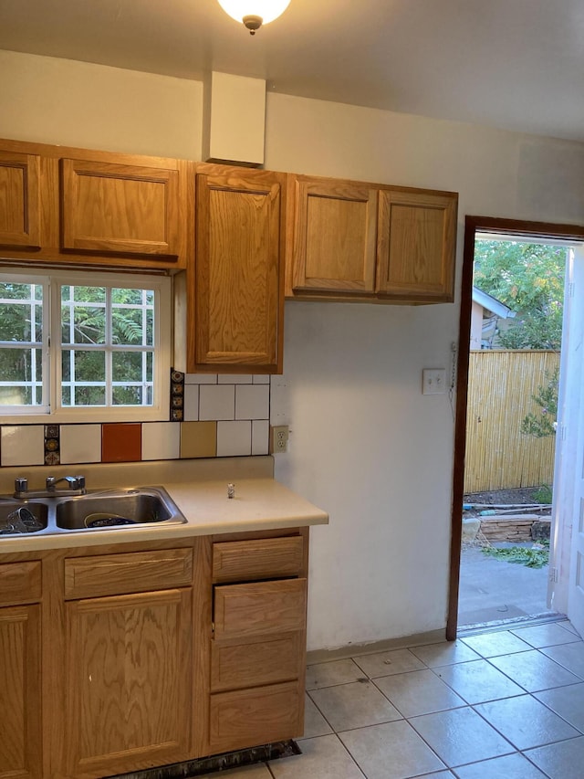 kitchen with backsplash, sink, and light tile patterned floors